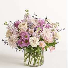 Bouquet of pink and white flowers in a clear glass vase