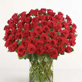 Large bouquet of red roses in a clear glass vase