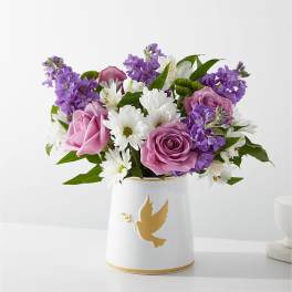 Pink and purple roses with white daisies in a white vase