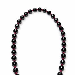 Black beaded necklace with a gold clasp on a white background