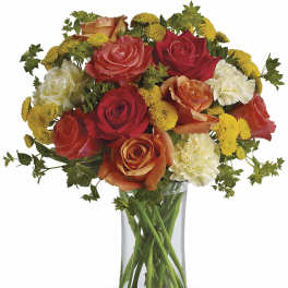 Mixed roses and carnations in a clear glass vase