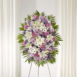 Standing floral spray with pink roses, white lilies, and purple flowers