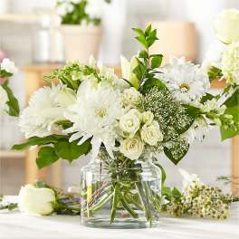 White floral arrangement in a clear glass vase