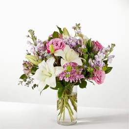 Pink and white flower bouquet in a clear glass vase