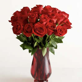 Bouquet of red roses in a red glass vase