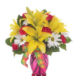 Yellow lilies with red carnations and white daisies in a bright pink vase with plaid ribbon