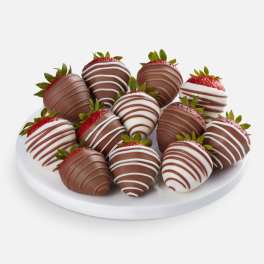 Plate of chocolate-covered strawberries with white drizzle