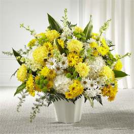 Yellow and white mixed flower arrangement in a white vase