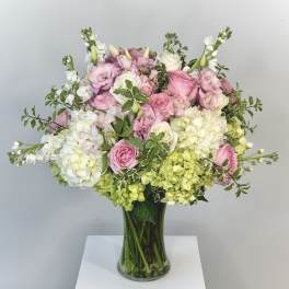 Pink and white mixed bouquet in a clear glass vase