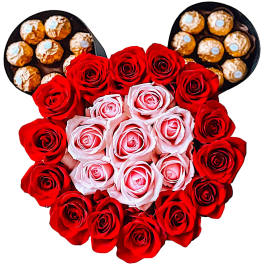 Heart-shaped rose arrangement with chocolates at the top