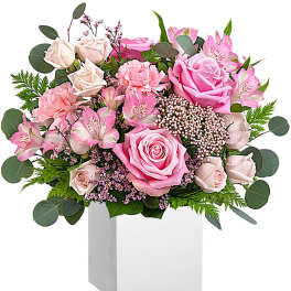 Pink roses and alstroemeria in a white box vase