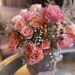 Pink and peach rose bouquet with baby's breath and berry accents