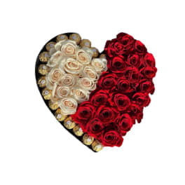 Heart-shaped arrangement of red and white roses with gold-wrapped chocolates