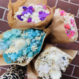 Bouquets of dried flowers wrapped in brown paper