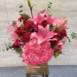 Pink and red floral arrangement in a clear glass vase