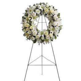 White floral funeral wreath on a standing easel
