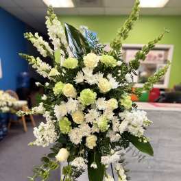 Tall white and pale green floral standing spray on an easel