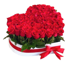 Heart-shaped arrangement of red roses with a red ribbon