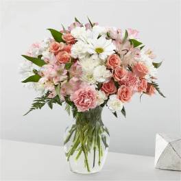 Pink and white mixed bouquet in a clear glass vase