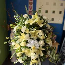 Large white and pale yellow floral spray with ribbon