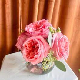 Pink roses arranged in a clear glass vase