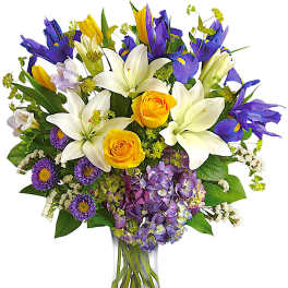 Bouquet of white lilies, yellow roses, and purple flowers in a glass vase