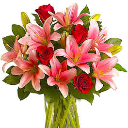 Pink lilies and red roses in a clear glass vase