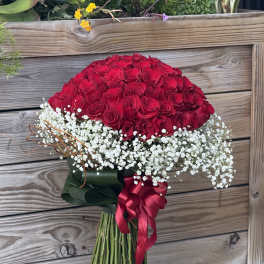Large bouquet of red roses with white baby's breath and ribbon
