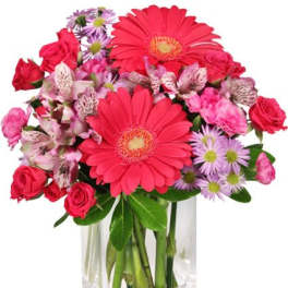 Pink and red mixed bouquet in a clear glass vase