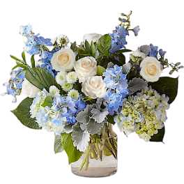 Blue and white flower arrangement in a clear glass vase