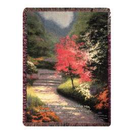 Fringed throw blanket with a scenic path and red tree design
