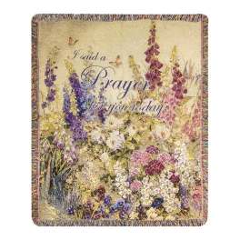 Floral prayer blanket with purple text and a multicolor flower garden design