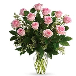 Pink roses arranged in a clear glass vase