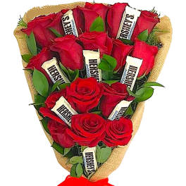Bouquet of red roses wrapped in burlap with a red ribbon