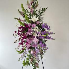 Tall standing floral spray with pink, purple, white, and green blooms
