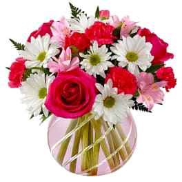 Pink and white mixed bouquet in a round glass vase