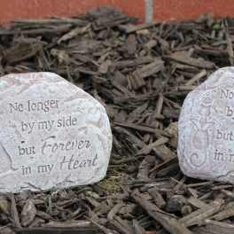Two memorial stones engraved with angel designs and a remembrance message