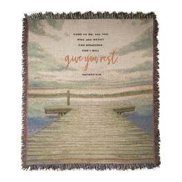 Fringed woven blanket with a dock scene and Bible verse text