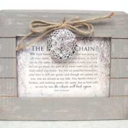 Framed memorial sign with a twine bow and decorative ornament