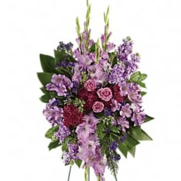 Purple and pink standing floral spray on an easel