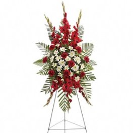 Standing floral spray of red and white flowers on an easel