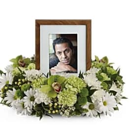 White and green floral photo frame arrangement with daisies