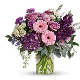 Pink and purple mixed bouquet in a clear glass vase