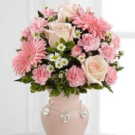 Pink and white flower arrangement in a decorative vase