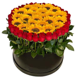 Round arrangement of yellow sunflowers and red roses in a black box