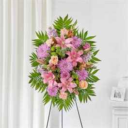 Pink and lavender floral standing spray on an easel