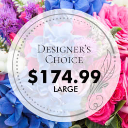 Designer’s choice floral arrangement with blue, pink, and purple blooms