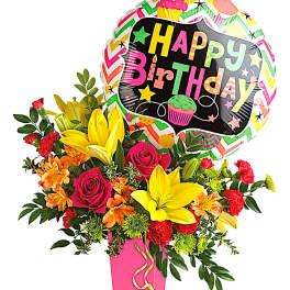 Birthday bouquet with roses, lilies, and a balloon in a pink vase