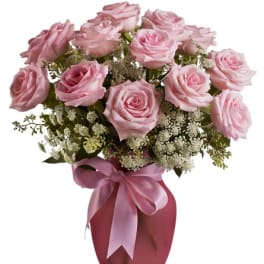 Pink roses in a vase with a satin ribbon