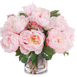 Pink peonies arranged in a clear glass vase